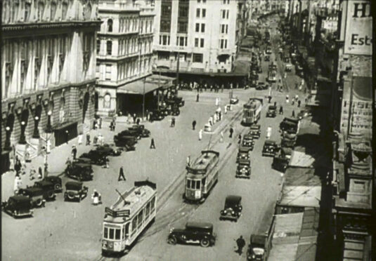 Looking south down Queen Street, Auckland , New Zealand with the Auckland Chief Post Office building to the left. Circa 1942