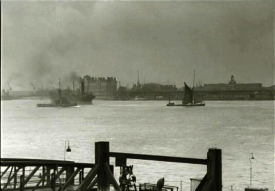 Viewed from Gravesend West Street Pier (Kent), Tilbury Riverside Station (Essex) (closed 1992) and what is now Tilbury Cruise Terminal to the right on opposite bank together with 'Tilbury Hotel' to the left, ravaged by an incendiary fire in 1944. Circa 1942