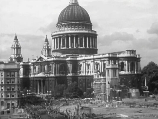 St. Paul’s Cathedral with the troops marching along Cannon Street, EC4 in the foreground. The tower of the 17th Century St Augustine’s Church is also to be seen. Circa 1942