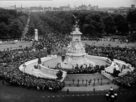 “London in 1942 is the hub of the war effort.” Queen Victoria Memorial Monument and The Mall as seen from Buckingham Palace.