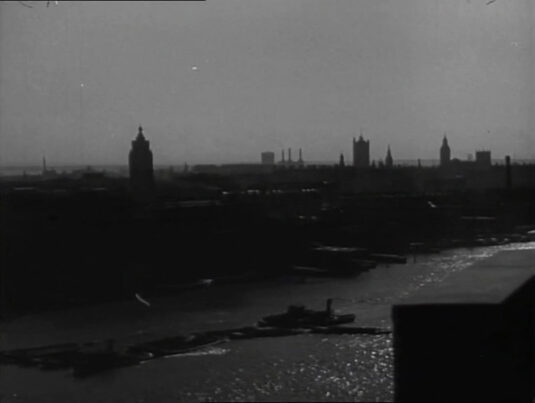 A view across the Thames with the Oxo Tower left of center and the Houses of Parliament to the right of capture. Circa 1942