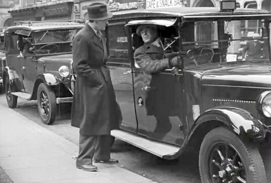 The background shops are 1 - 4 Railway Place, London EC3 now known as St. Katherine's Row. Circa 1949
