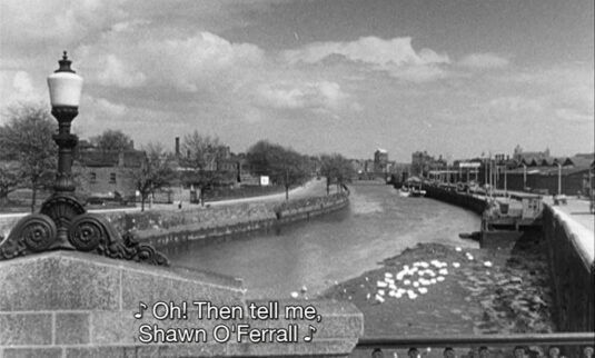 The view east down the River Liffey from Frank Sherwin Bridge where it joins Victoria Quay. Circa 1957
