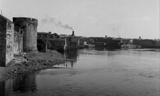 River Shannon bordered on the left by King John’s Castle aka Limerick Castle, Limerick. Circa 1957
