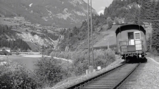 In the far background, can be seen the road bridge over the river Inn, connecting the railway station to the historic market town of Imst, which is out of view to the left. Above it, is the Karrer tunnel of the Tyrol major road. Circa 1955