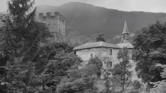 The hilltop castle of St. Petersberg, west of Silz village in Tyrol, seen from across the local pond. Circa 1955