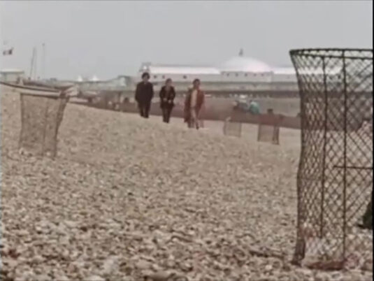Brighton beach with Brighton Palace Pier in the background. Circa 1970