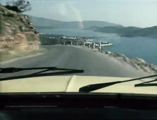 Travelling northbound between Agios Nikolaos and Elounda, the Elounda Beach Hotel is visible on the right. Circa 1977