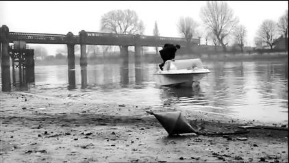 The River Thames with Fulham Railway Bridge crossing in the background. Circa 1965