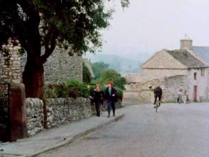 The children walk through the village following a visit to Julian. Main Road, Taddington, Derbyshire .PR Circa 1985