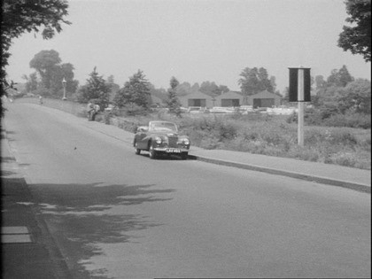 Walton Bridge Road with the old Walton Bridge just behind Sallie's car Circa 1955