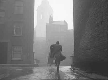 Parker Mews, looking out to Parker Street, and the tower of Freemasons’ Hall beyond. Circa 1952