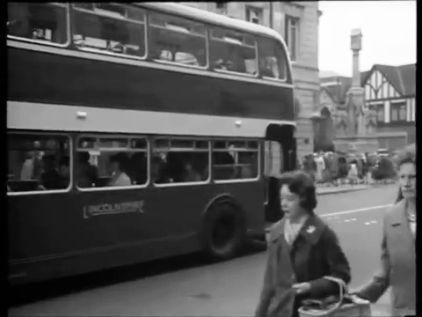 High Street with Lincoln War Memorial as well as St. Benedict's Square and Church visible to the right. Circa 1962